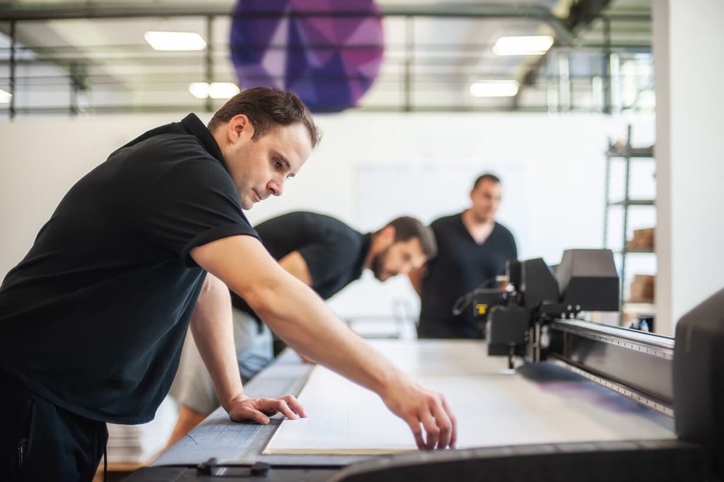 Several men working in a printing shop